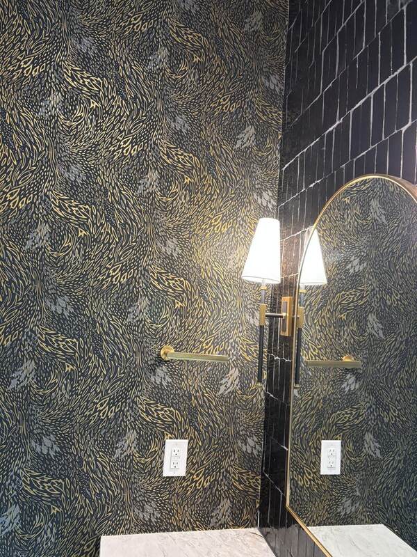 Gold abstract metallic wallpaper in a compact Austin powder room